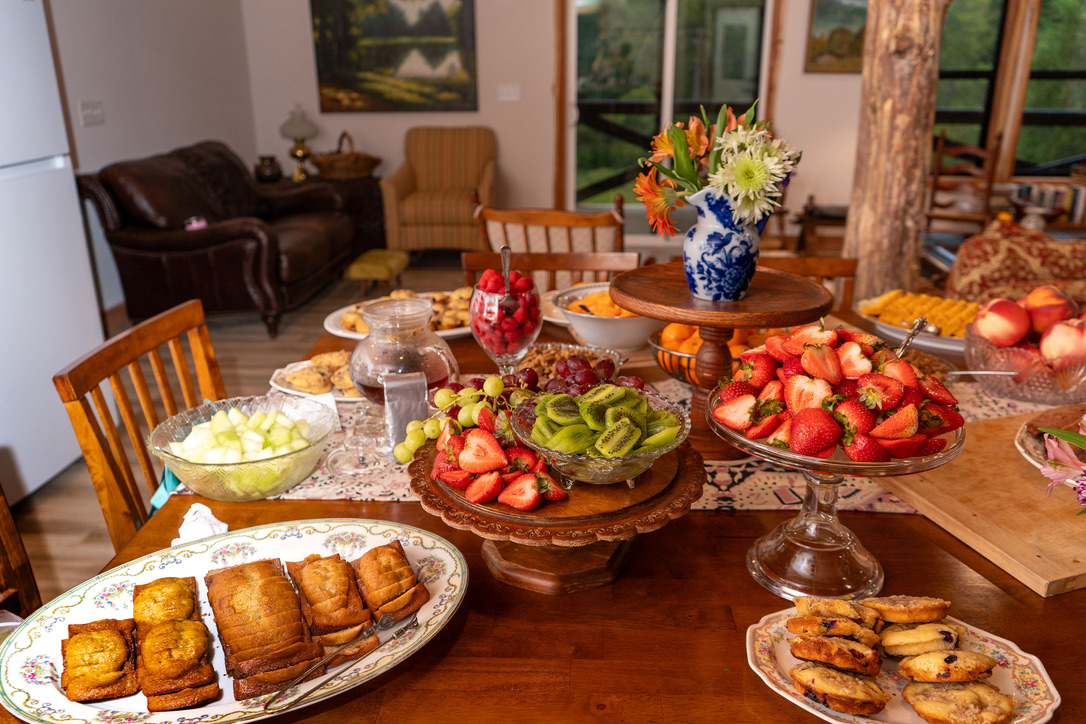 Scratch-made breakfast spread with fresh fruit and baked goods at Snug Hollow Farm